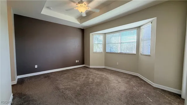 a view of an empty room with a ceiling fan