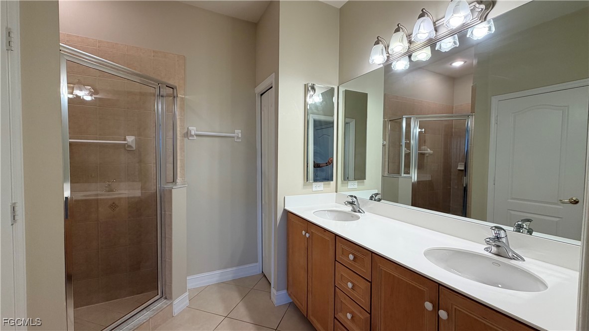 13071 Sandy Key Bend, Unit 304 North Fort Myers, FL 33903 - Photo 21 of 37 a bathroom with a double vanity sink and a mirror