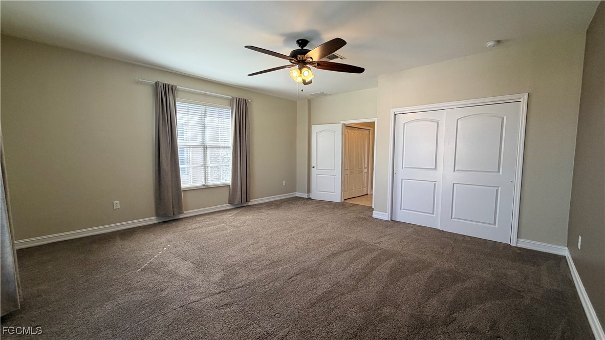 13071 Sandy Key Bend, Unit 304 North Fort Myers, FL 33903 - Photo 28 of 37 a view of an empty room with a ceiling fan