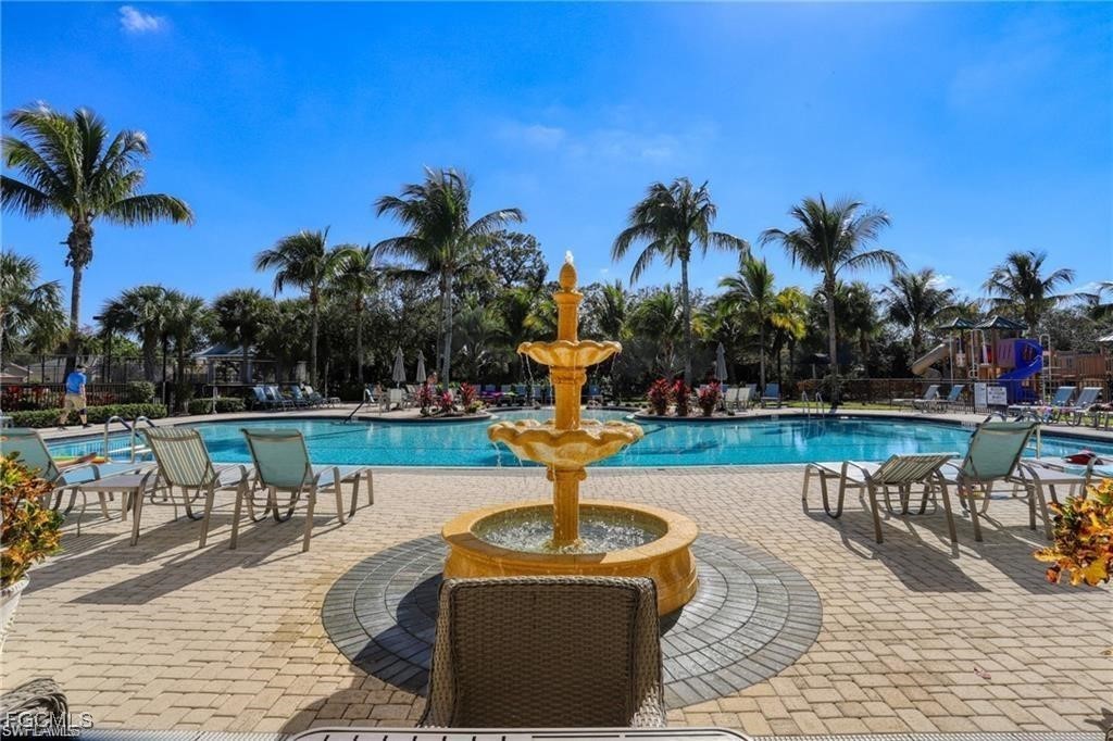 13071 Sandy Key Bend, Unit 304 North Fort Myers, FL 33903 - Photo 35 of 37 a swimming pool with outdoor seating and yard
