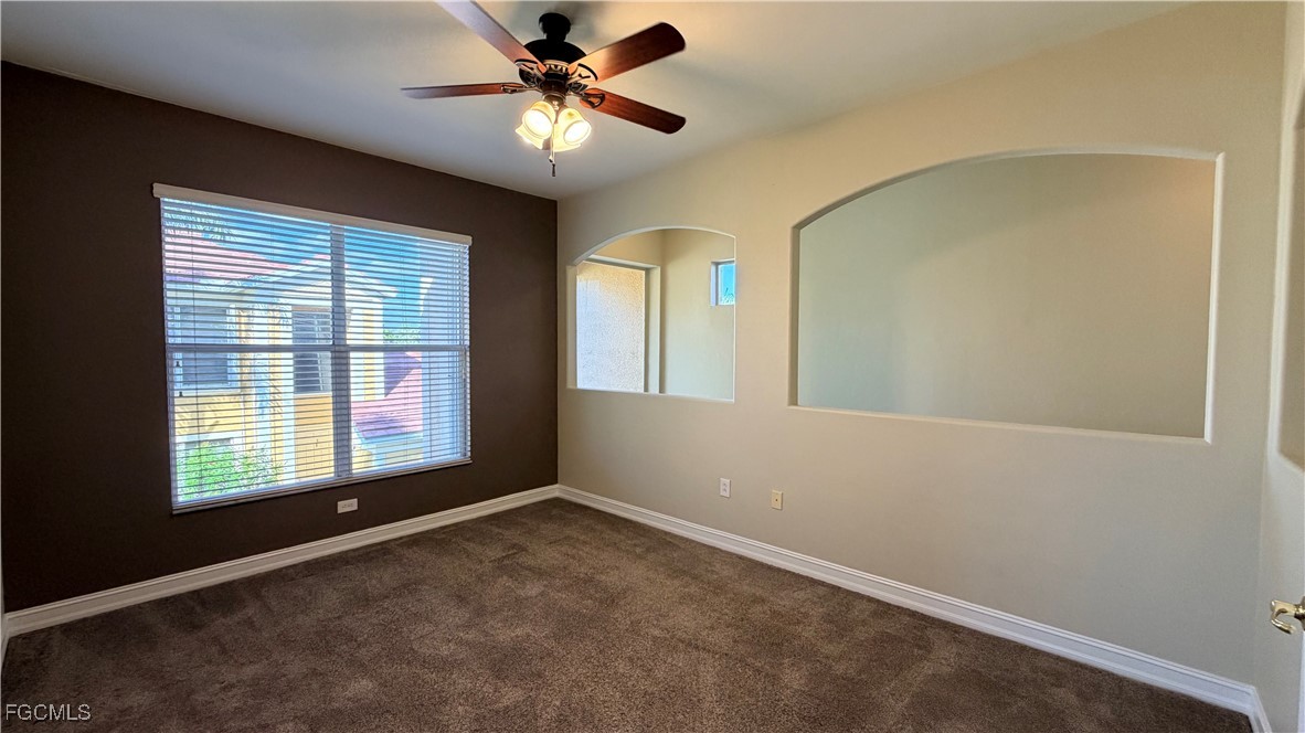 13071 Sandy Key Bend, Unit 304 North Fort Myers, FL 33903 - Photo 5 of 37 an empty room with windows and fan