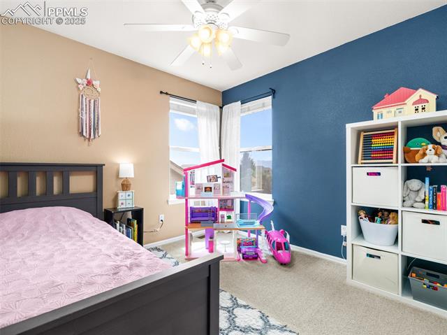 5346 Gentle Wind Road Colorado Springs, CO 80922 - Photo 16 of 28 Bedroom featuring baseboards, carpet flooring, and a ceiling fan