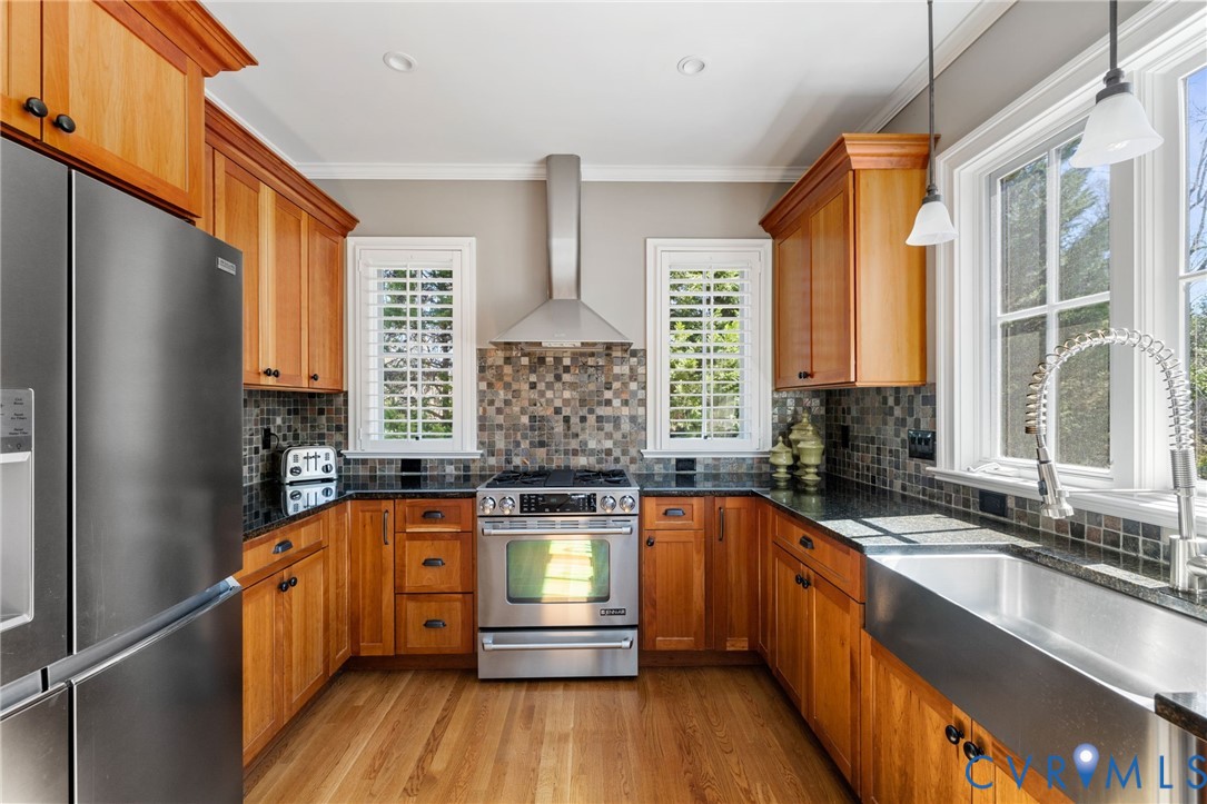 8947 Cherokee Road Richmond, VA 23235 - Photo 14 of 45 a kitchen with wooden floors a sink and a window
