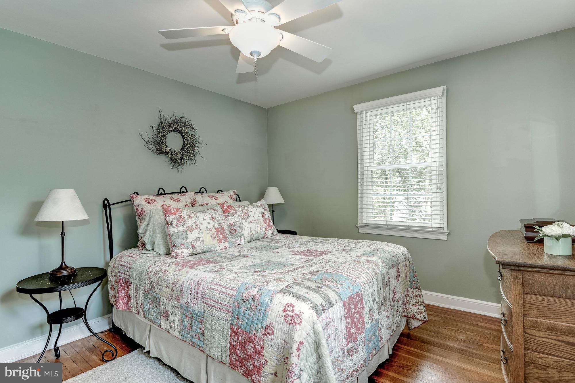 9109 Eton Road Silver Spring, MD 20901 - Photo 12 of 30 a bedroom with a bed and a chandelier