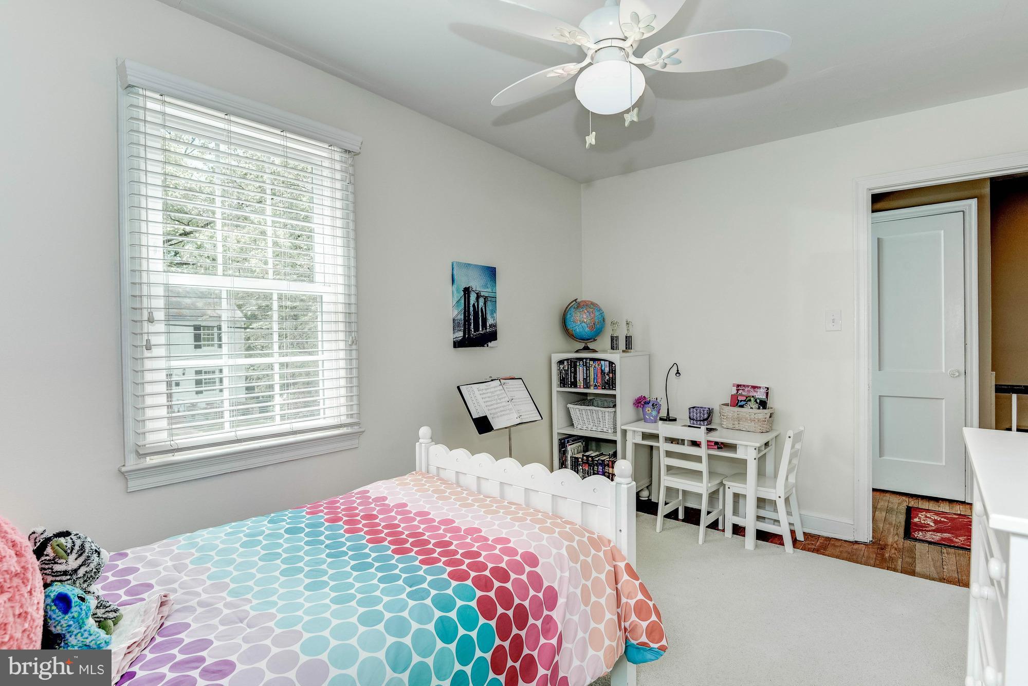 9109 Eton Road Silver Spring, MD 20901 - Photo 14 of 30 a bedroom with a bed and a chandelier