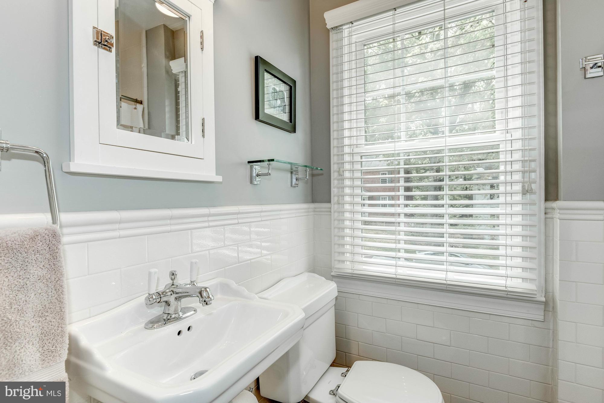 9109 Eton Road Silver Spring, MD 20901 - Photo 16 of 30 a bathroom with a sink a toilet and a mirror