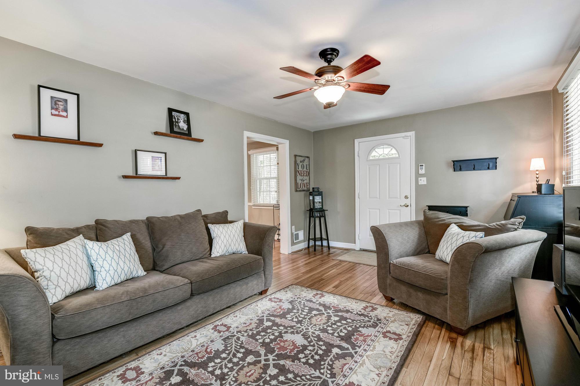 9109 Eton Road Silver Spring, MD 20901 - Photo 4 of 30 a living room with furniture and a wooden floor
