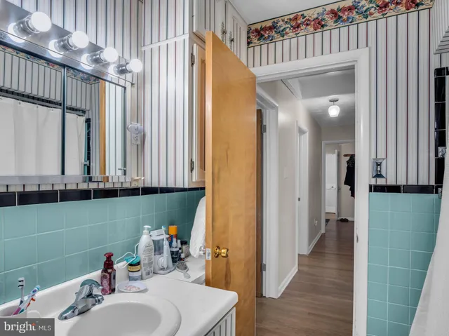 a view of a patio with table and chairs potted plants and floor to ceiling window