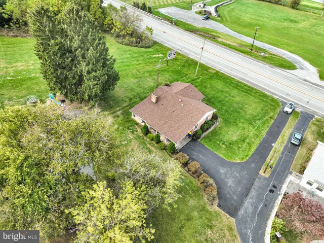 a backyard of a house with lots of green space and lake view