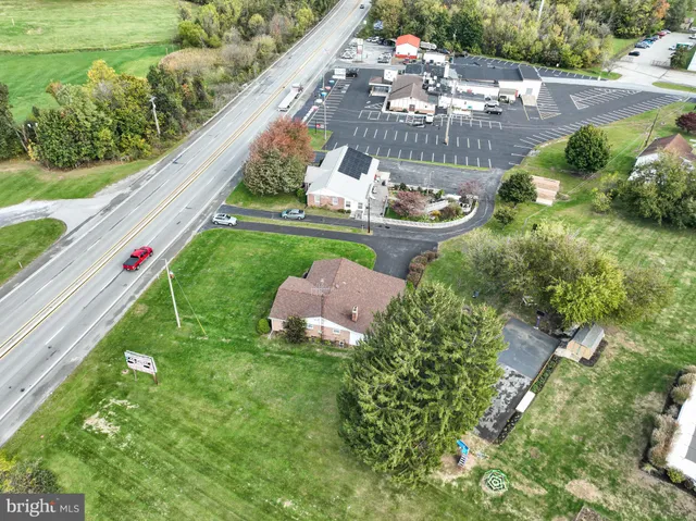 an aerial view of a house with a yard