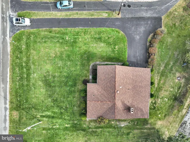 an aerial view of residential houses with outdoor space and river