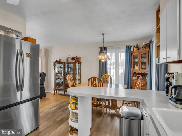 a kitchen with stainless steel appliances granite countertop a sink refrigerator and microwave