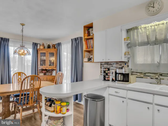 a kitchen with a dining table and chairs