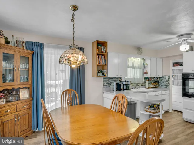 a view of a dining room with furniture and chandelier