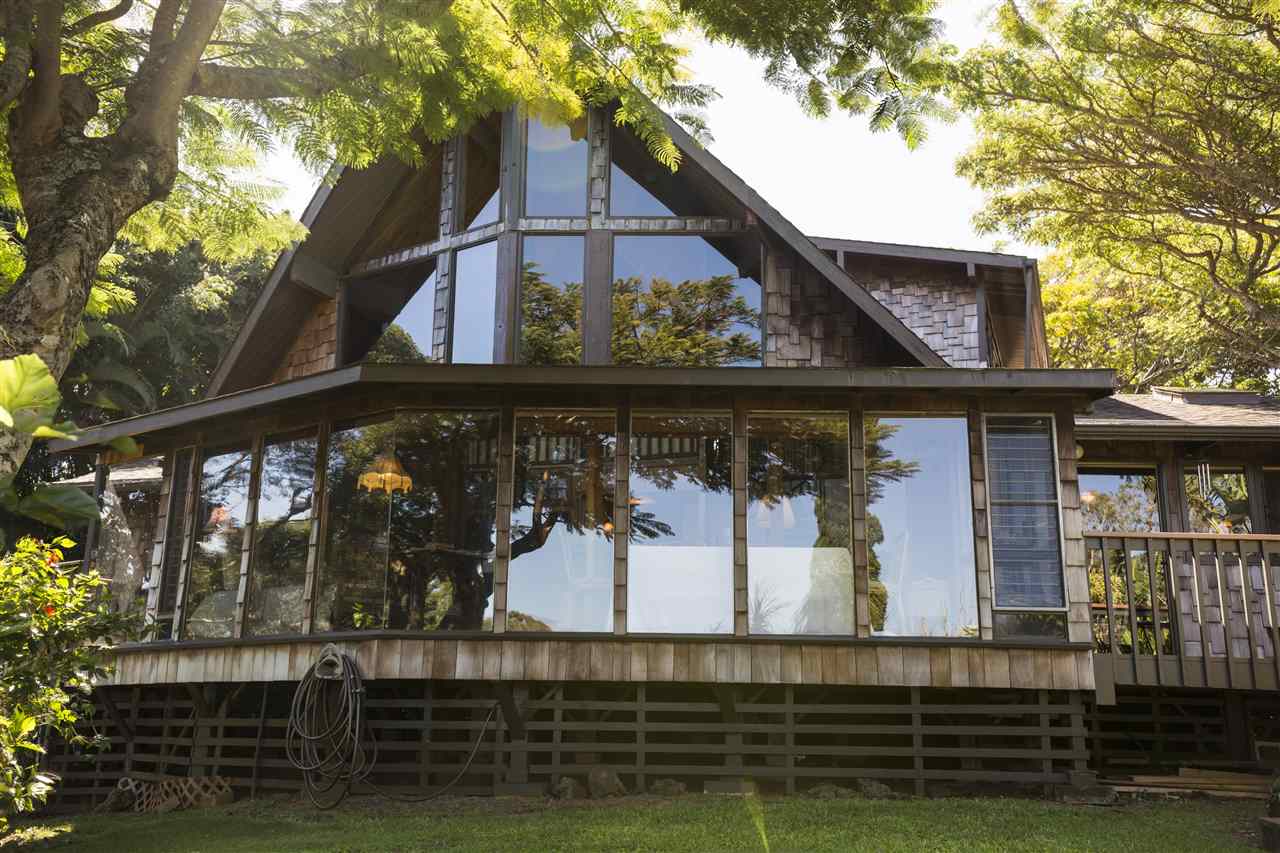 a view of a small house with large windows and a table