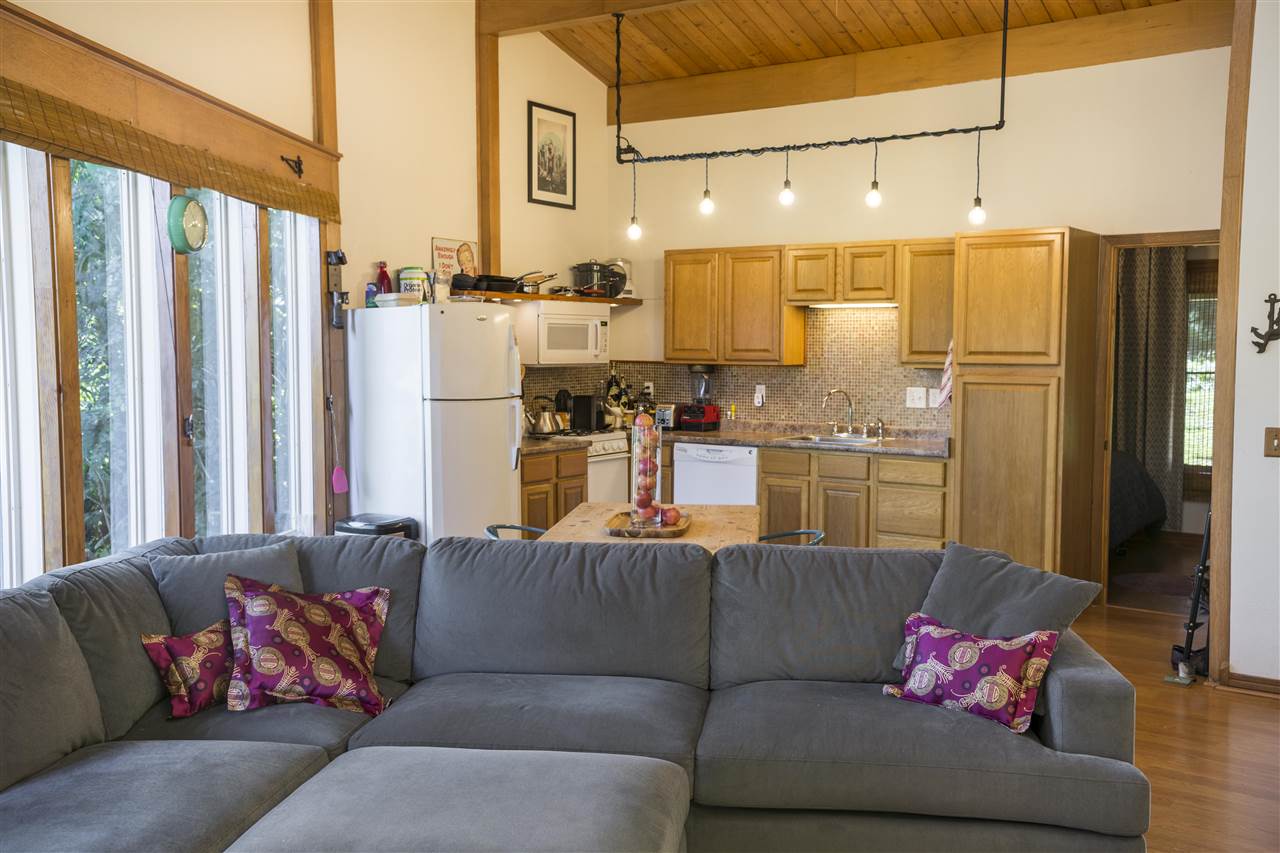 2555 Lemi Place Haiku, HI 96708 - Photo 22 of 30 a living room with furniture kitchen view and a chandelier