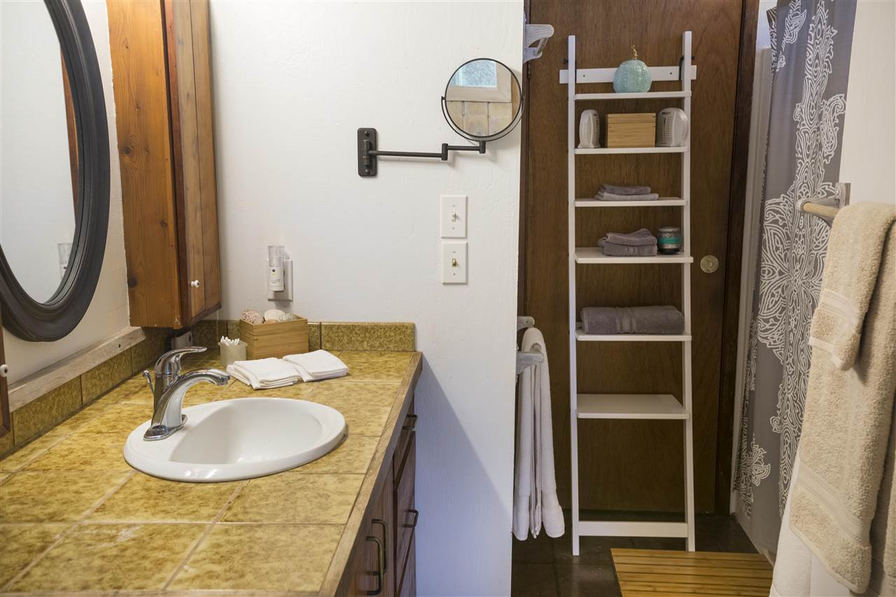 2555 Lemi Place Haiku, HI 96708 - Photo 24 of 30 a bathroom with a sink and a mirror