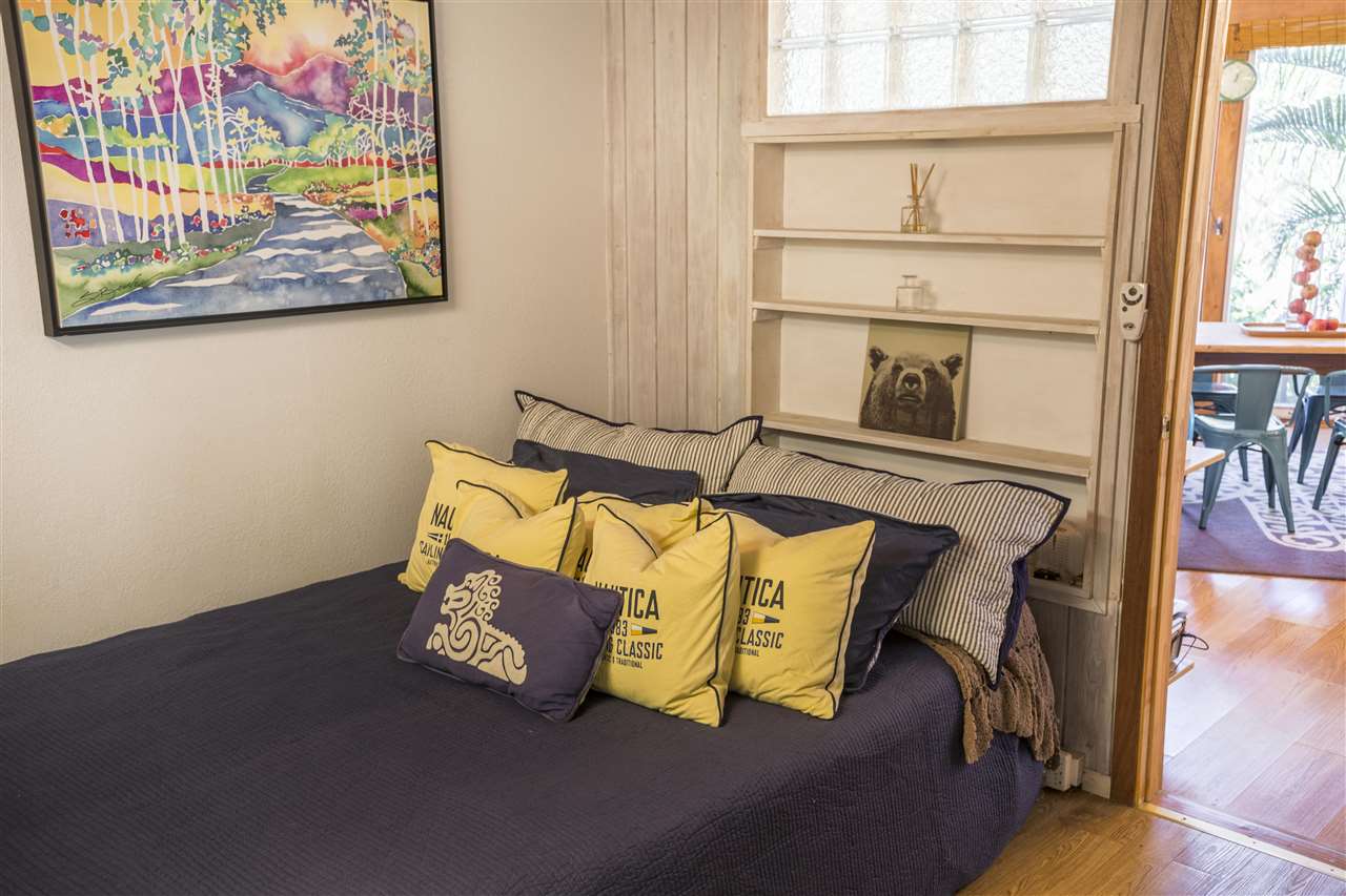 2555 Lemi Place Haiku, HI 96708 - Photo 27 of 30 a bed sitting in a bedroom next to a window