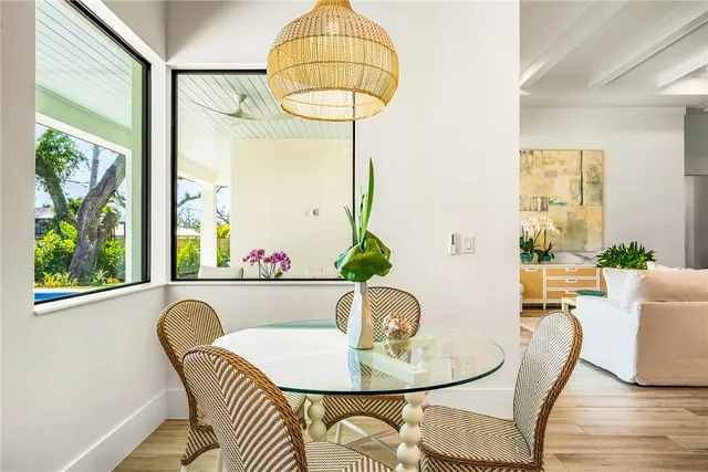 a dining room with furniture a window and wooden floor
