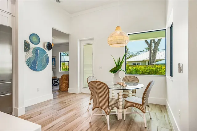 a dining room table chair and glass door with glass windows