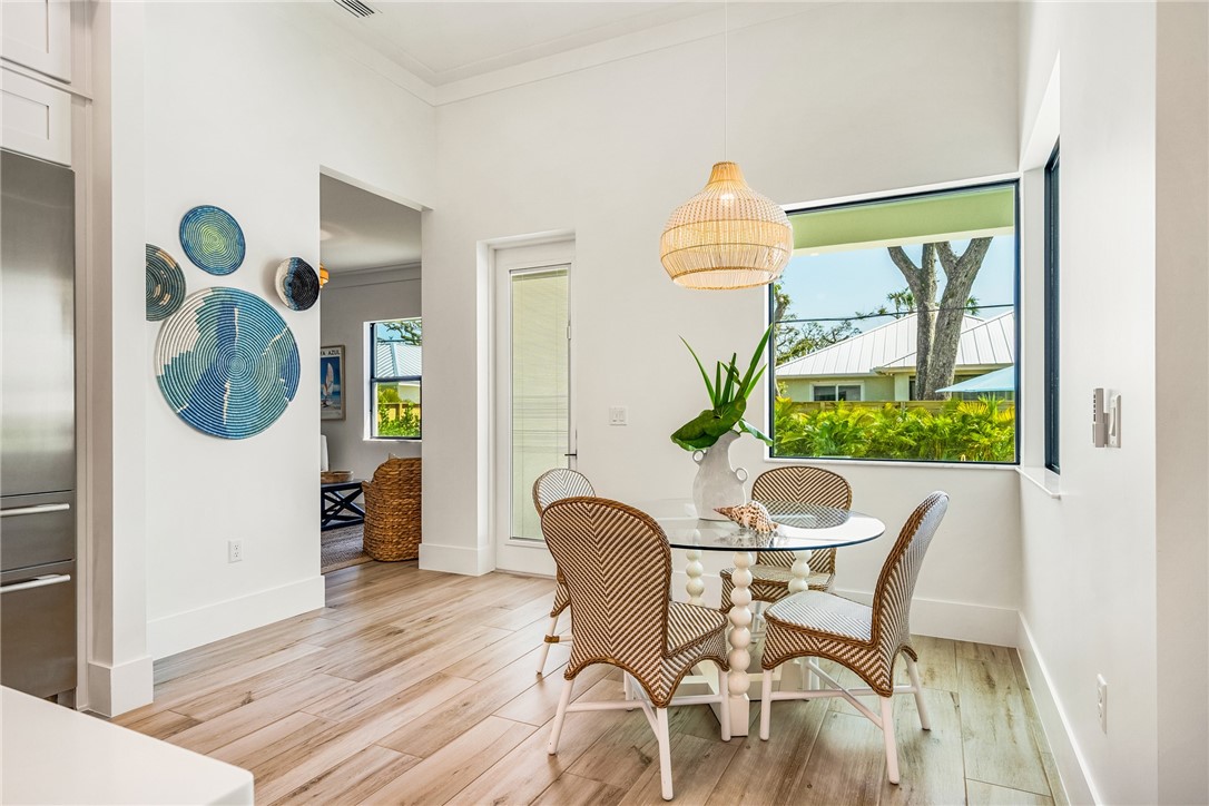 636 Cypress Road Vero Beach, FL 32963 - Photo 13 of 32 a dining room table chair and glass door with glass windows