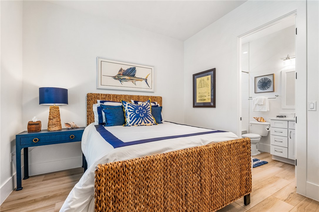 636 Cypress Road Vero Beach, FL 32963 - Photo 21 of 32 a bedroom with a bed and a lamp on table