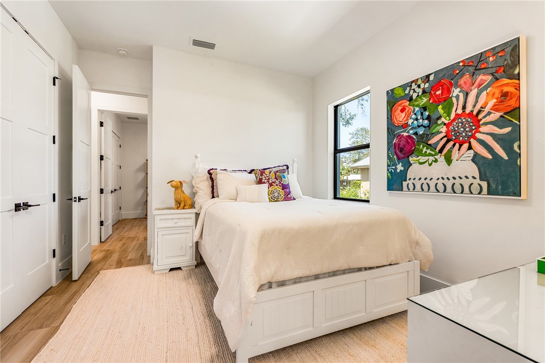 636 Cypress Road Vero Beach, FL 32963 - Photo 21 of 32 a bedroom with a bed and painting on the wall