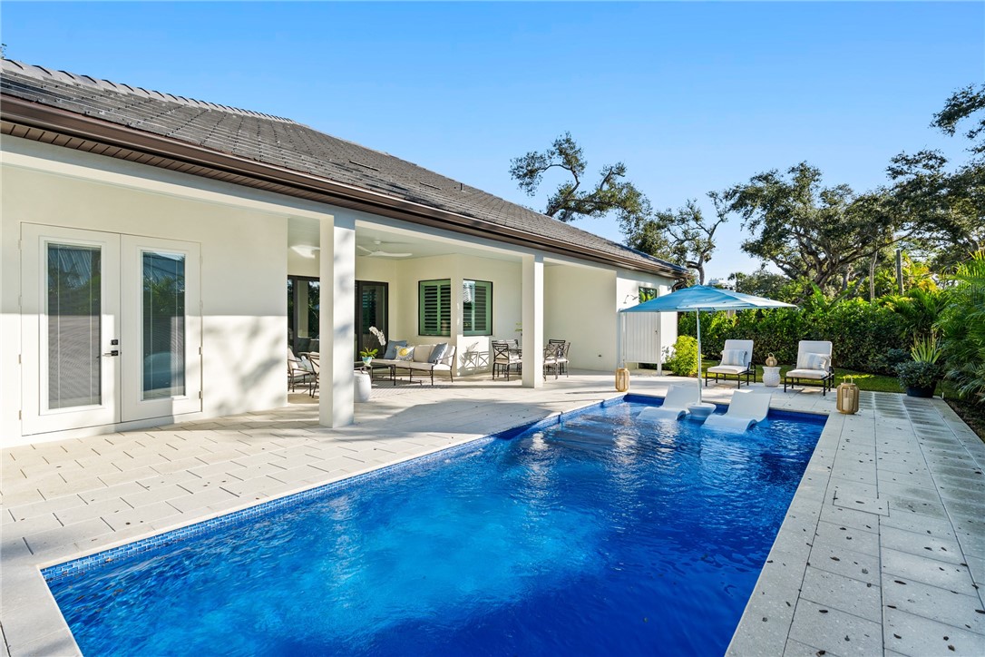 636 Cypress Road Vero Beach, FL 32963 - Photo 28 of 32 a view of a house with dining room and swimming pool