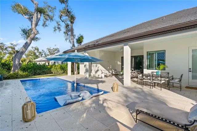 a view of swimming pool with outdoor seating and plants