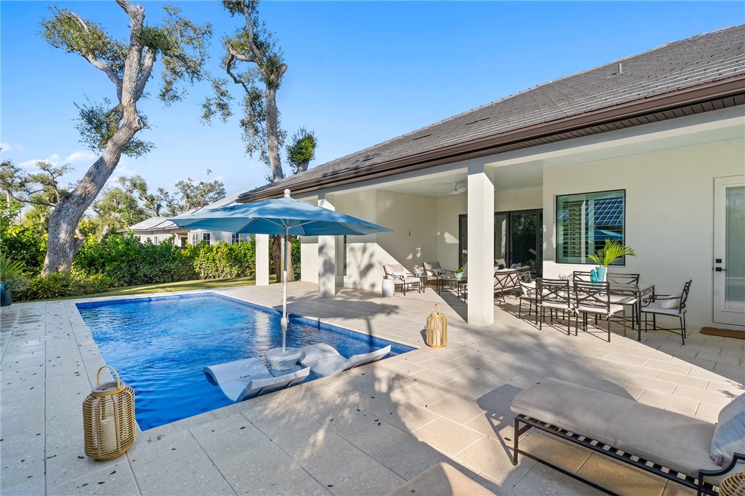 636 Cypress Road Vero Beach, FL 32963 - Photo 29 of 32 a view of swimming pool with outdoor seating and plants
