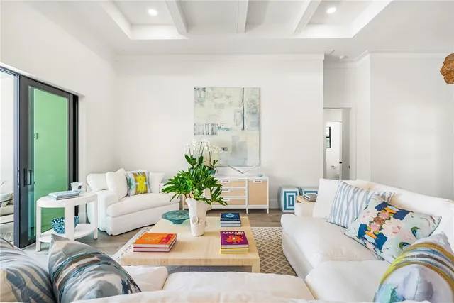 a living room with furniture fireplace and potted plant