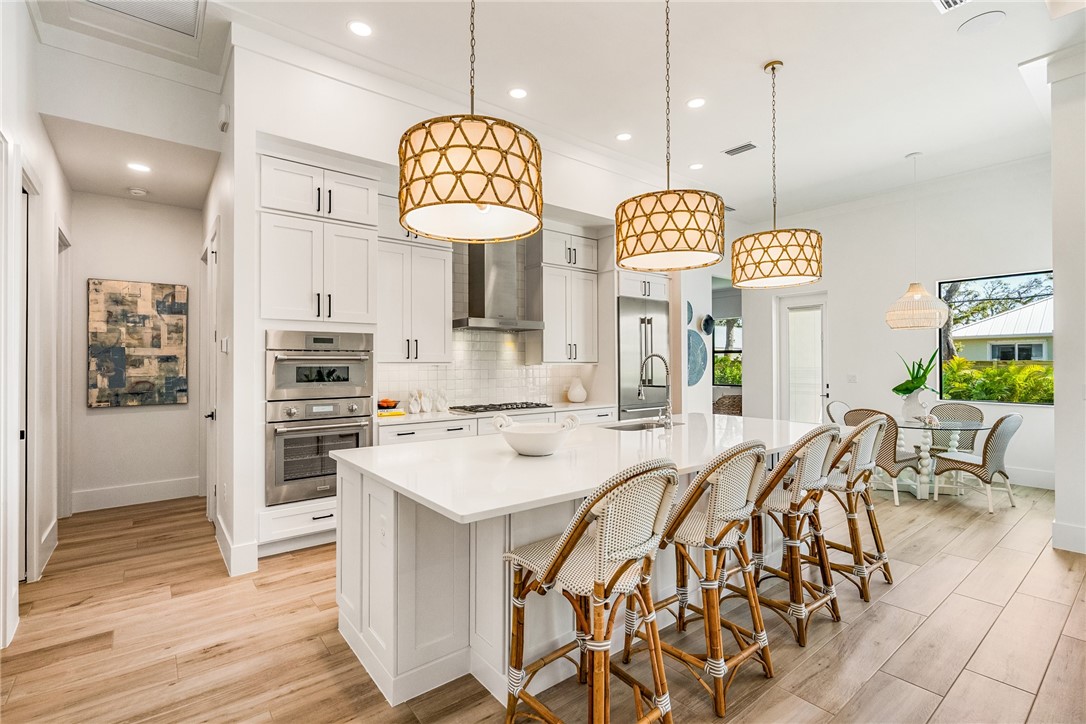 636 Cypress Road Vero Beach, FL 32963 - Photo 9 of 32 a large kitchen with a table and chairs in it