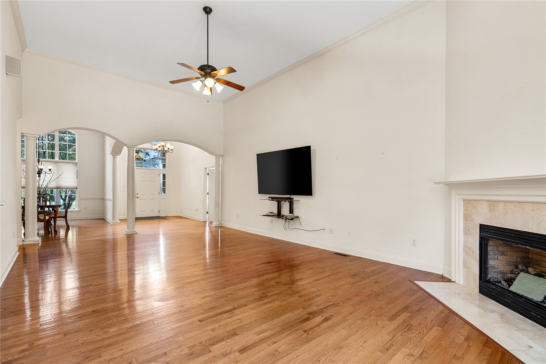 135 Sunset Bay Boulevard Seneca, SC 29672 - Photo 11 of 50 Natural light illuminates rich hardwood floors, extending through arched doorways to an inviting entry.