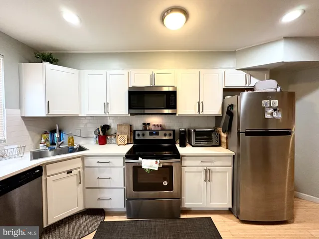 a kitchen with a white stove and refrigerator