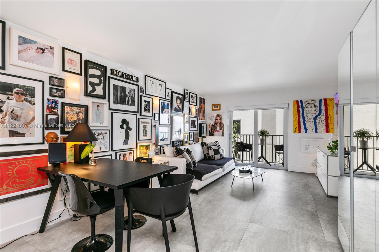 a living room with furniture kitchen view and a large window