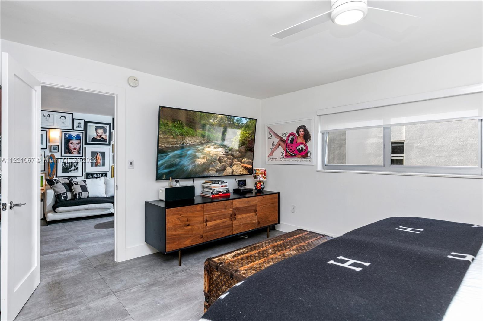 1674 Bay Road, Unit 504 Miami Beach, FL 33139 - Photo 12 of 25 a living room with furniture and a flat screen tv