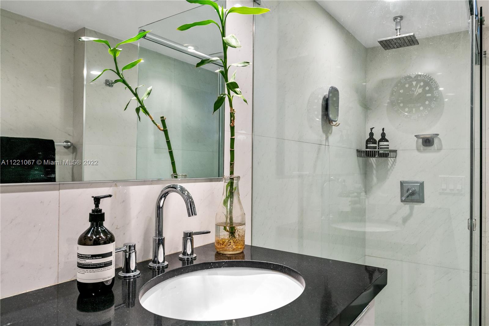 1674 Bay Road, Unit 504 Miami Beach, FL 33139 - Photo 15 of 25 a bathroom with a sink and a mirror