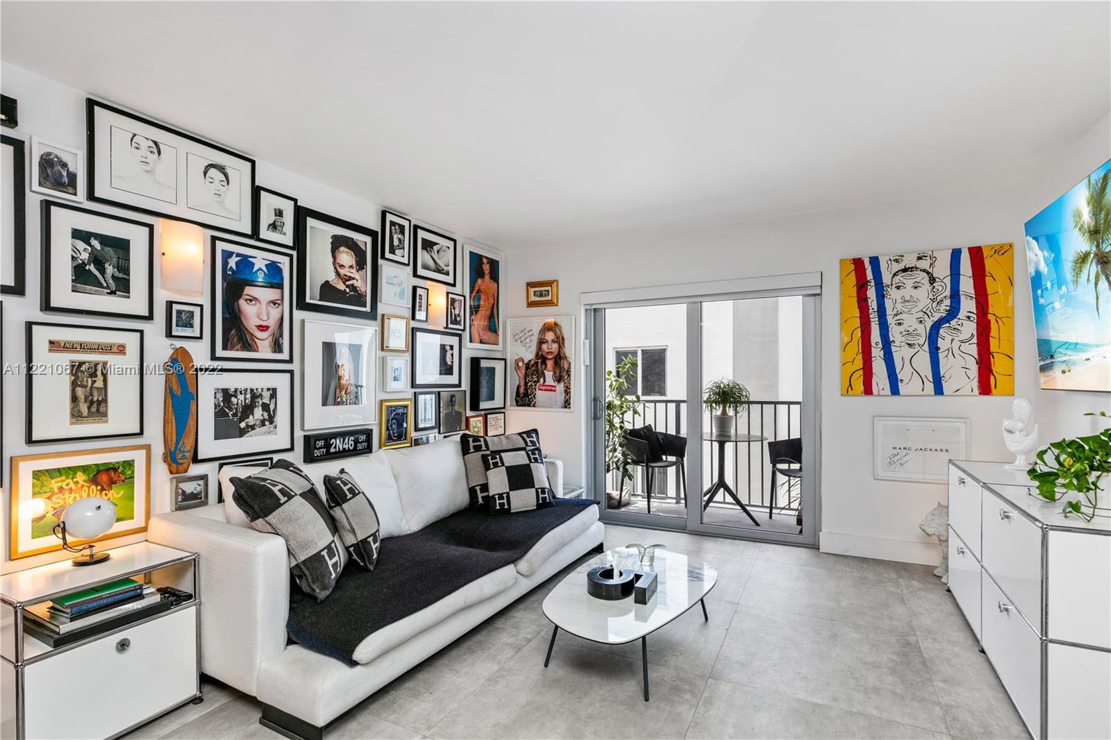1674 Bay Road, Unit 504 Miami Beach, FL 33139 - Photo 2 of 25 a living room with fireplace furniture and a book shelf