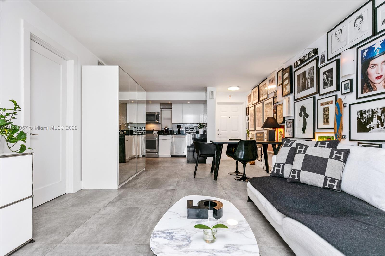 1674 Bay Road, Unit 504 Miami Beach, FL 33139 - Photo 7 of 25 a living room with lots of furniture and kitchen view