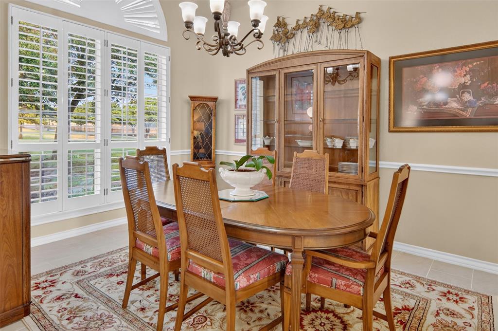 272 Edward Farris Road Weatherford, TX 76085 - Photo 7 of 40 Recessed arched window with plantation shutters, crown molding, chair rail, and an ornate chandelier
