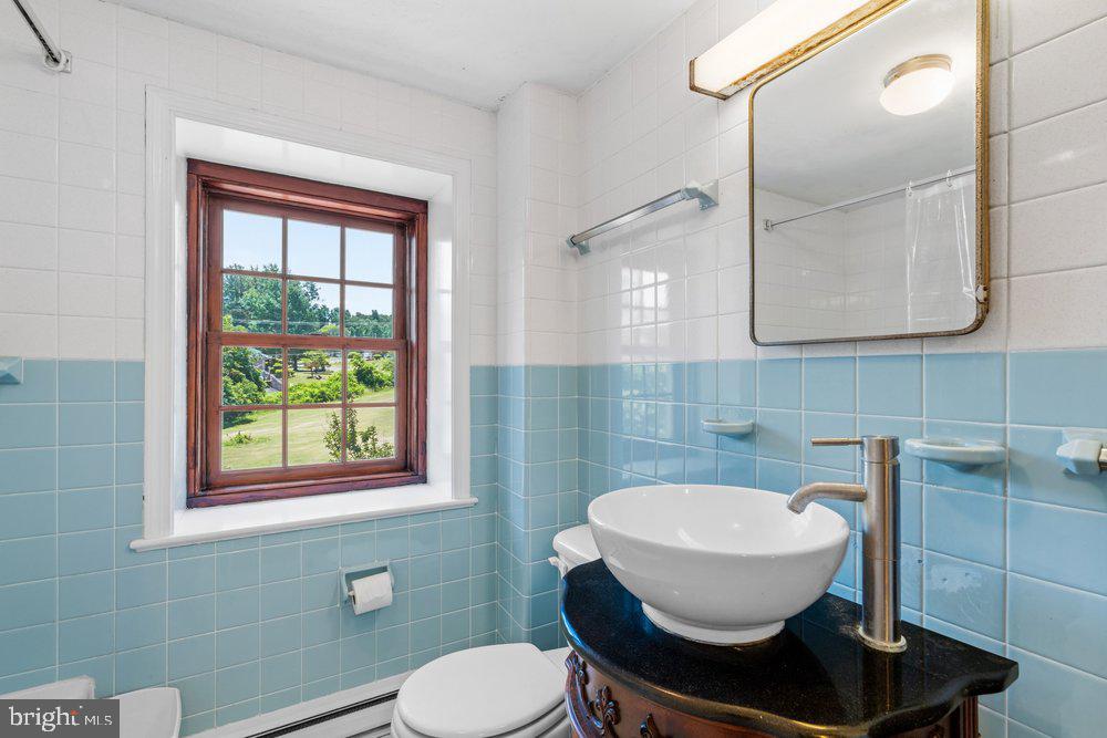 201 East Moyer Road Pottstown, PA 19464 - Photo 41 of 64 a bathroom with a toilet a sink and mirror