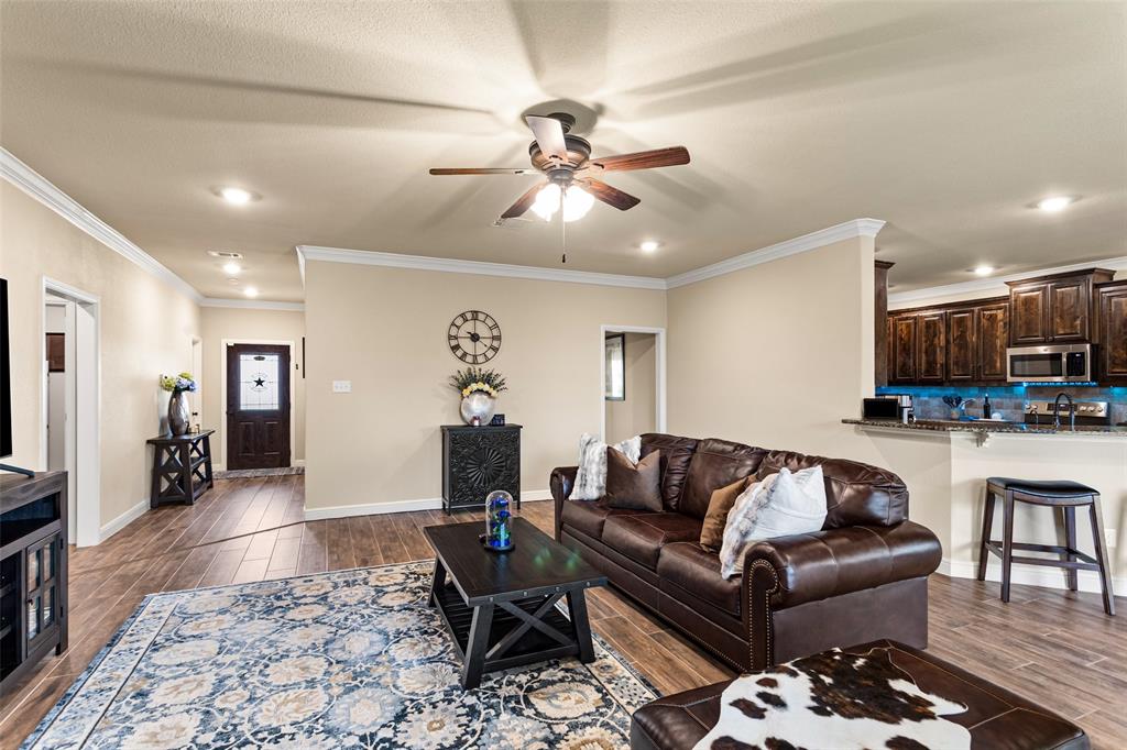 223 Cottongame Road Weatherford, TX 76088 - Photo 9 of 39 a living room with furniture and kitchen view