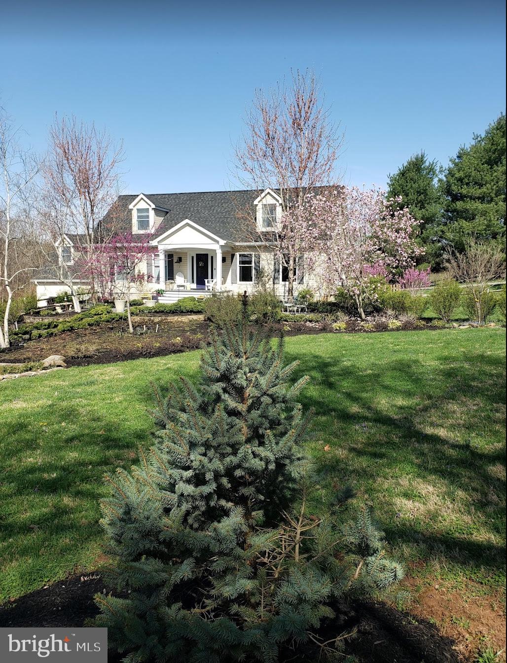 22235 Newlin Mill Road Middleburg, VA 20117 - Photo 6 of 106 a front view of a house with a garden