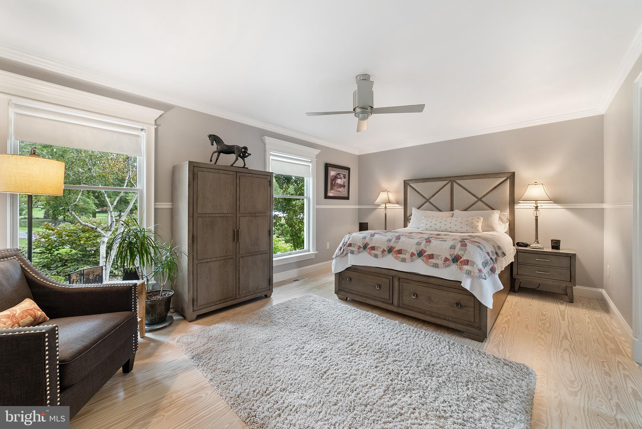 22235 Newlin Mill Road Middleburg, VA 20117 - Photo 52 of 106 a spacious bedroom with a bed and a couch