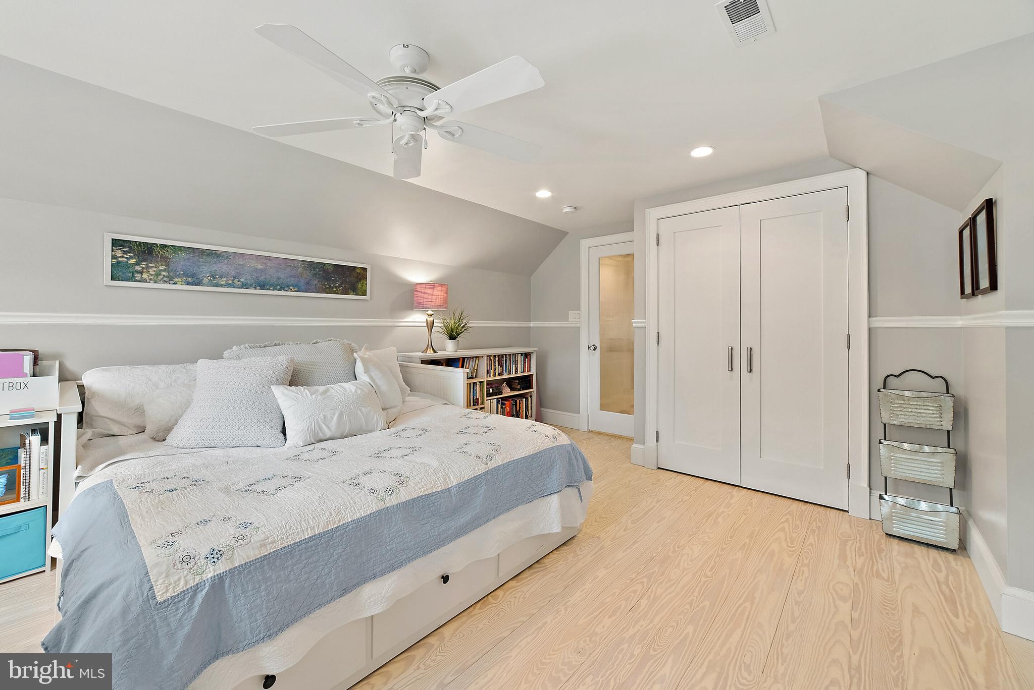 22235 Newlin Mill Road Middleburg, VA 20117 - Photo 64 of 106 a spacious bedroom with a bed a chandelier and a dresser