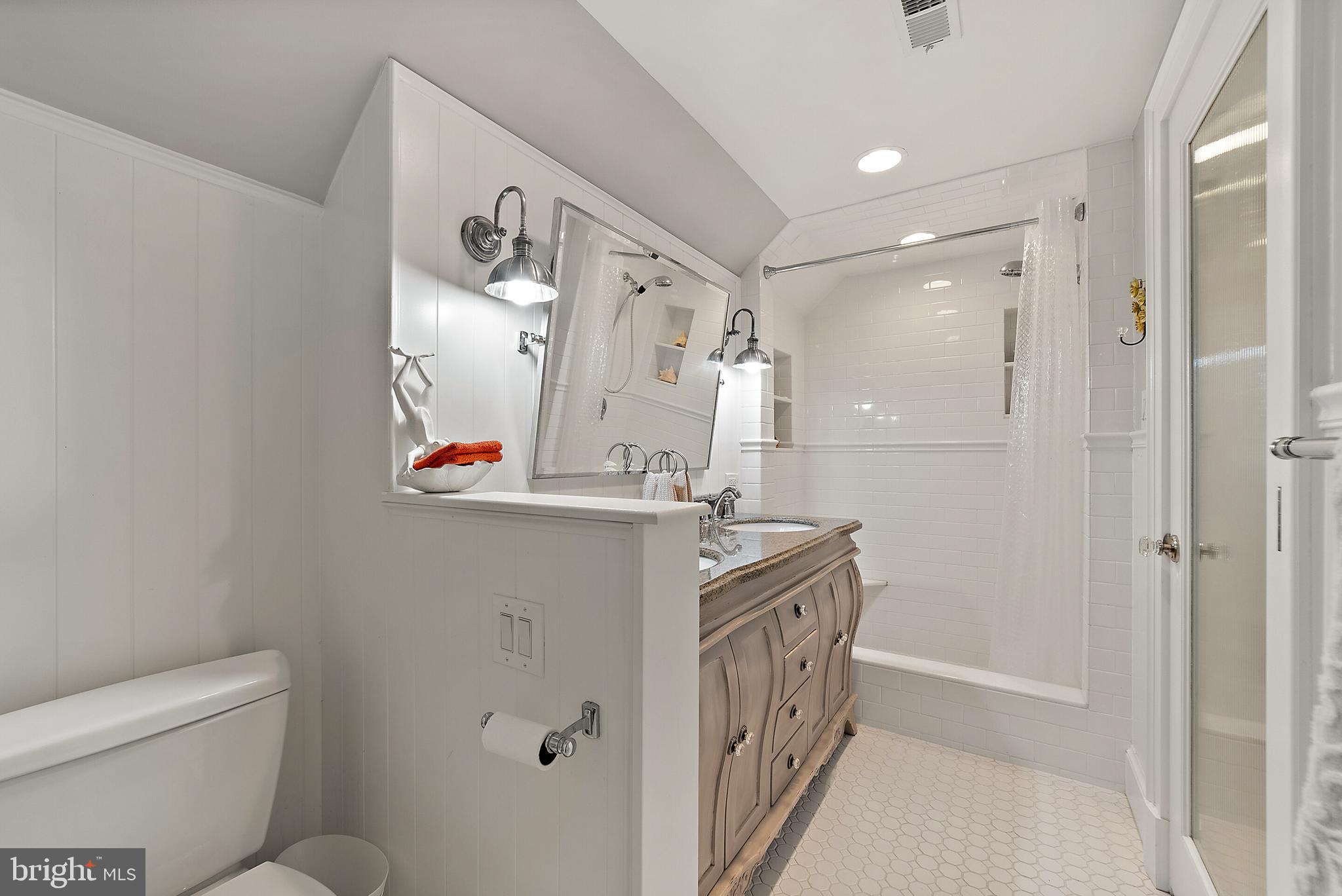 22235 Newlin Mill Road Middleburg, VA 20117 - Photo 69 of 106 a bathroom with a granite countertop sink a mirror a toilet and a shower