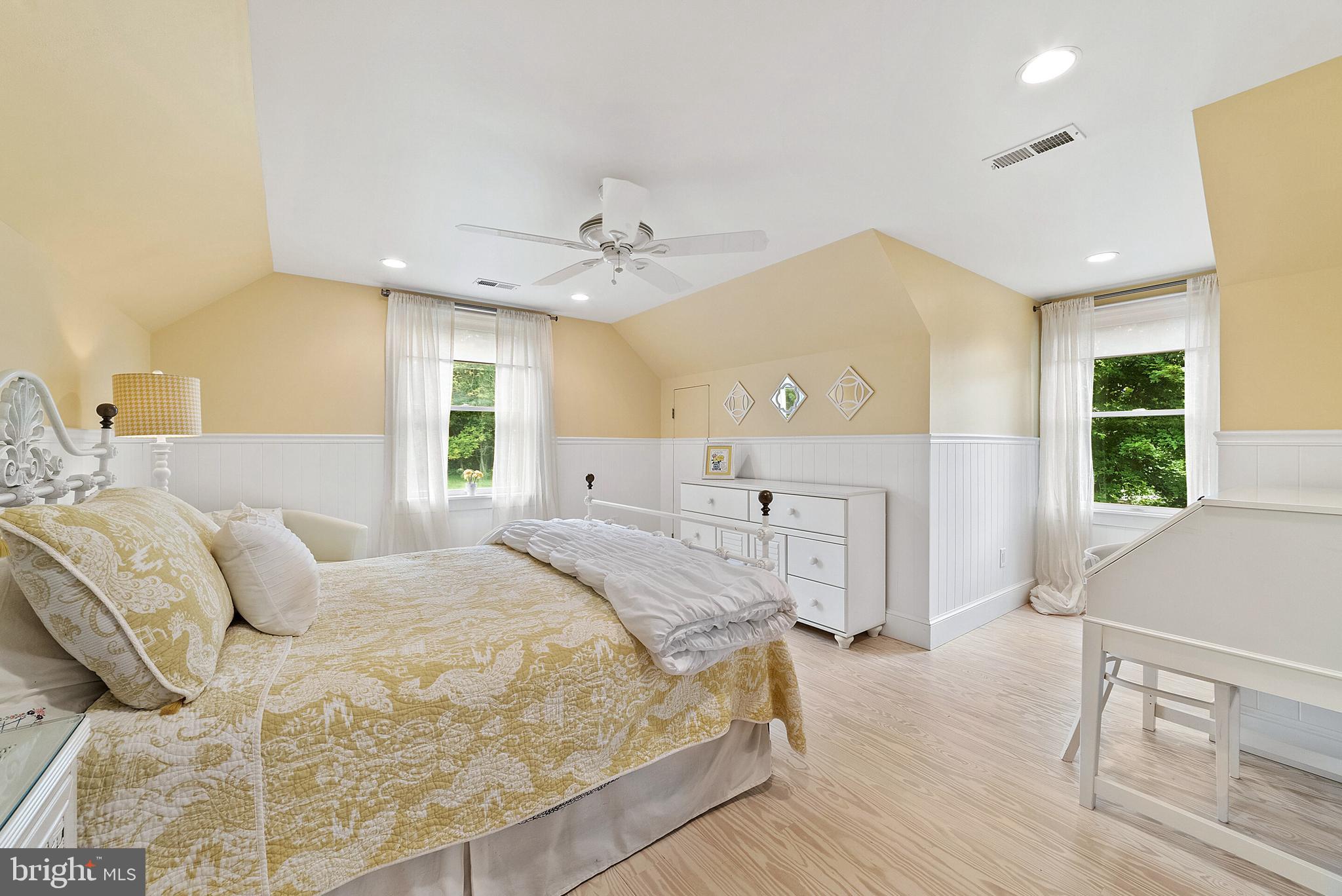 22235 Newlin Mill Road Middleburg, VA 20117 - Photo 70 of 106 a spacious bedroom with a large bed a chandelier and windows