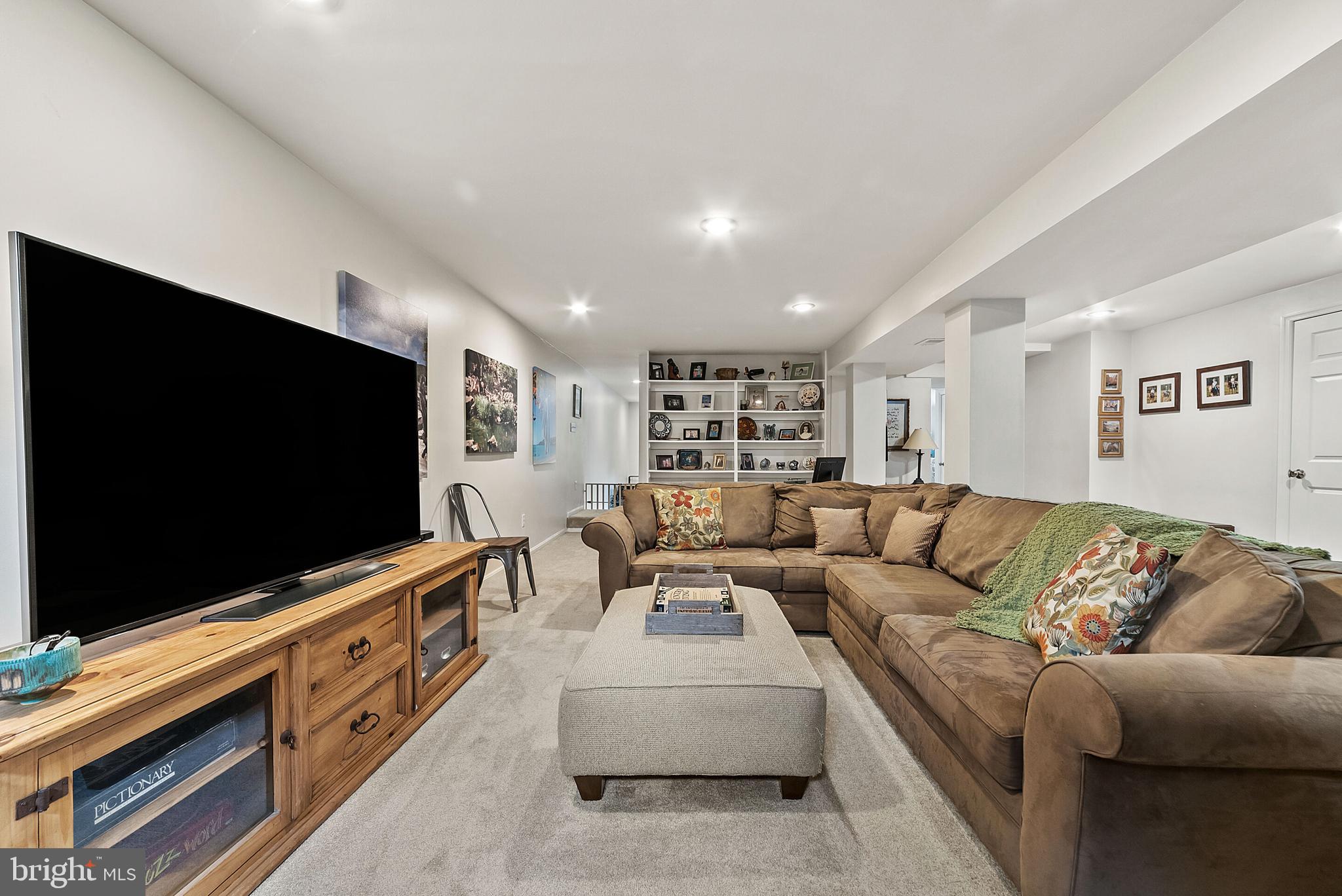 22235 Newlin Mill Road Middleburg, VA 20117 - Photo 75 of 106 a living room with furniture and a flat screen tv