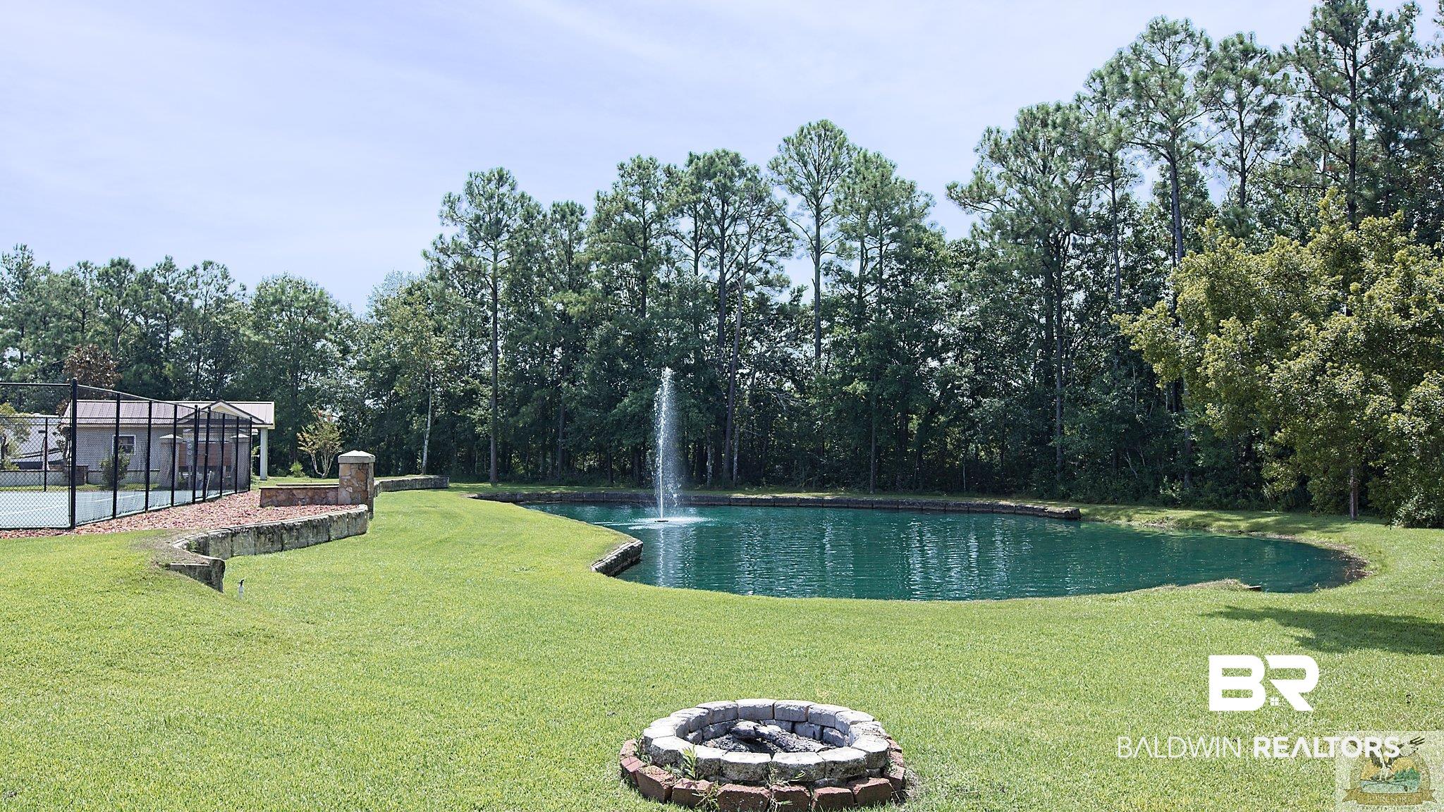 12489 Gateway Drive Elberta, AL 36530 - Photo 46 of 55 View of swimming pool with a lawn, fence, a water view, and a fire pit