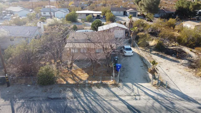 an aerial view of residential houses with outdoor space